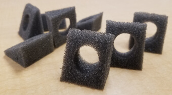 Open-cell foam pyramid-shaped parts with center hole, fabricated by Web Seal